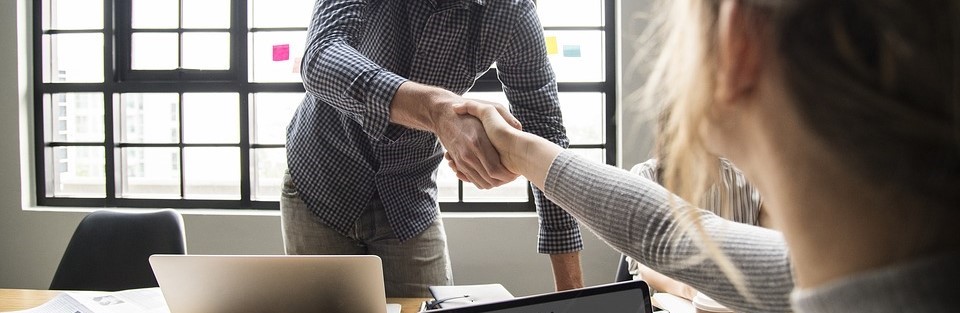 Bild von zwei Personen, die sich die Hand geben